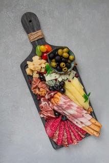 Appetizer, assortment, set, sausage, and cheese, on a wooden board, top view, no people