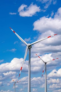 Wind turbine, wind energy plant from the manufacturer Enercon, blue sky with many white clouds,