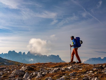Mountaineer with view of rose garden, Schlern, Dolomites, South Tyrol, Italy, Europe