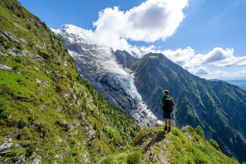 Mountaineer in front of impressive mountain landscape with glacier, view of glacier Glacier de