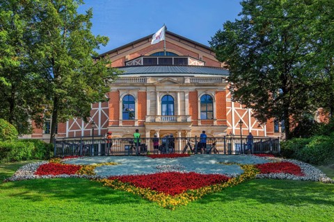 Flower border with the Richard Wagner Festival Theatre of the Bayreuth Festival on the Green Hill,