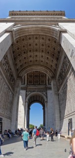 Tourists walk through the impressive Arc de Triomphe in Paris, Paris
