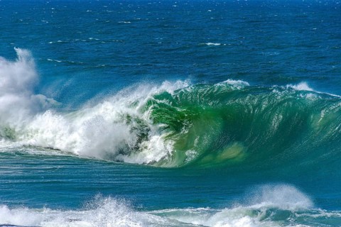 Big wave crashing hard onto the beach on a sunny day after a tropical storm, Ipanema Beach, Rio de