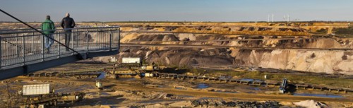 Two men on the Jackerath viewing platform look out over the Garzweiler open-cast lignite mine,