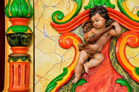 Wooden figure, colourfully painted, cherub at a carousel organ, fairground organ, historic