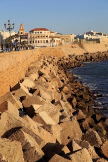 Coastal view east of rock armour coastal defences near city centre, Cadiz, Spain, Europe