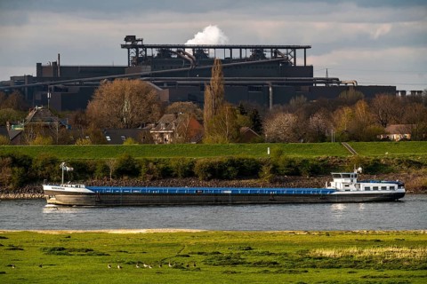 Cargo ship on the Rhine near Duisburg-Beeckerwerth, industrial backdrop of the ThyssenKrupp Steel