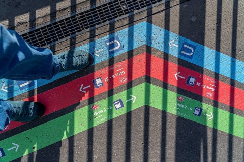 Signpost on the pavement, for bus and train diversions at Dortmund Central Station, during