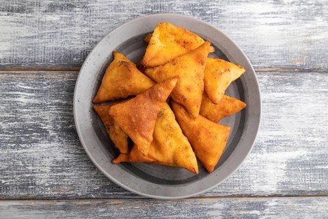 Nachos on a gray plate on a gray wooden background. Top view, close up