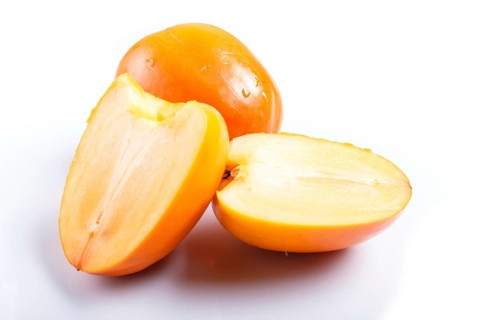 Ripe orange persimmon isolated on white background. closeup