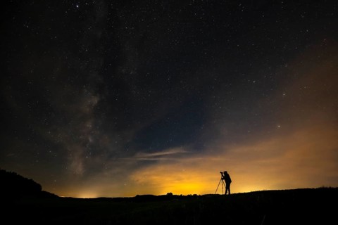 Photographer with tripod in a meadow with starry sky, Mindelheim, Unterallgäu, Bavaria, Germany,
