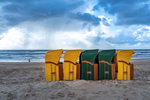 End of the season on the beach, dark storm clouds, choppy sea, autumn on the North Sea in North