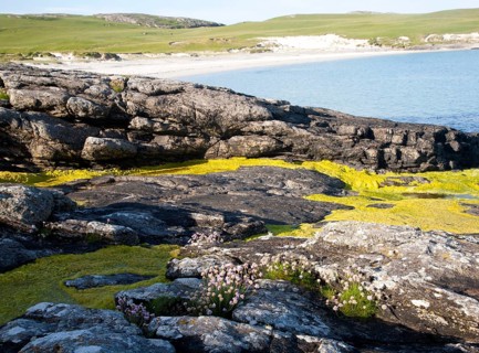 Rocky headland and sandy beach at Bagh a Deas, South Bay, Vatersay island, Barra, Outer Hebrides,