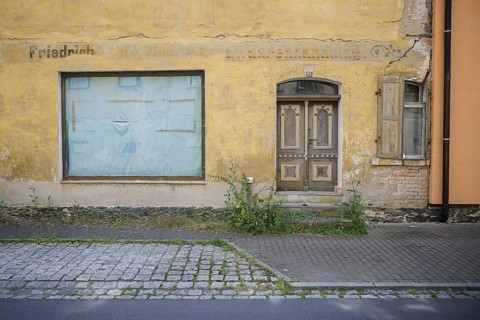Symbolic photo on the subject of vacant shops in rural areas. A taped-up shop window in a vacant