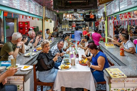 Visitors sitting at a table at a food stall, Mercado Central de San José, San José, Costa Rica,