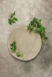 Grey clay plate, handmade, with basil branches, top view, food background, food wallpaper for menu