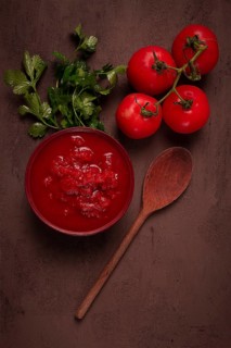 Tomatoes in their own juice, sliced, tomato sauce, tomatoes, in a cup, top view, close-up, no