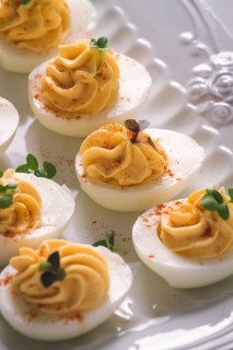 Boiled eggs stuffed with yolk with mayonnaise, on a white plate, selective focus, blurry, close-up,