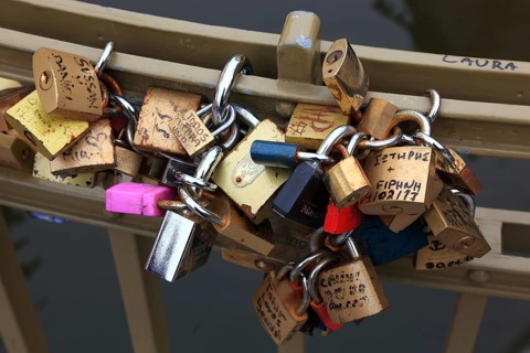 Lover's lock on a railing, love lock is a padlock which, according to custom, is attached to