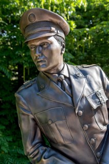 Bronze statue, monument to rock singer Elvis Presley, King of Rock 'n' Roll in uniform of the 3rd