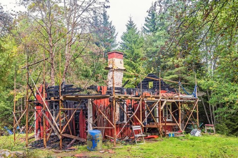 Wooden cottage that has burned down in the woodland, Sweden, Europe
