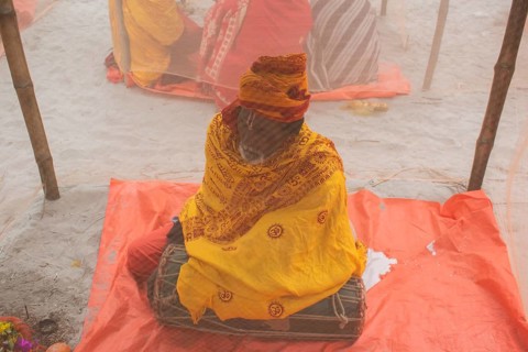 Devotees offer prayers at a tent city on the eve of consecration ceremony of the Ram temple, in