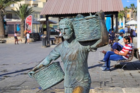 Fisherman statue sculpture in harbour at fishing village of Marsaxlokk, Malta, Europe
