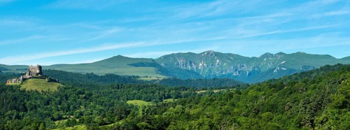 View of the medieval castle of Murol and the Sancy massif in the Auvergne Volcanoes Regional