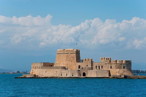 Old castle on a small island in the blue sea under a cloudy sky, fortress, Bourtz island, Bourtsi,