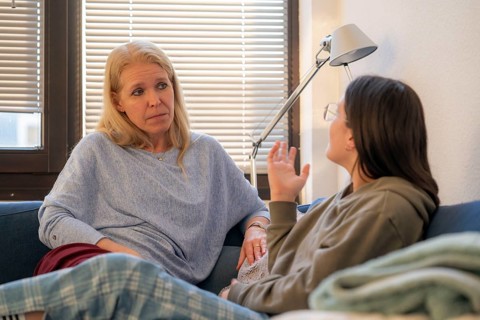 Mother and daughter, teenage, 13 years old, in a confidential conversation, at home