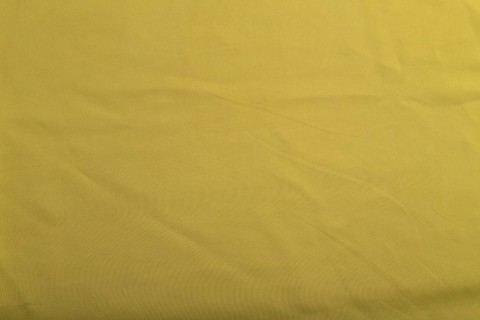 Fragment of smooth green olive silk tissue. Top view, flat lay, natural textile background and