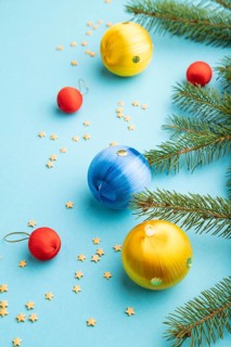 Christmas or New Year composition. Decorations, blue, red, yellow balls, fir and spruce branches,