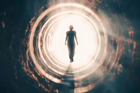 A woman walks through a tunnel into the light, symbolic image for near-death experience, death,