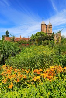 Red brick tower and blue sky Sissinghurst castle gardens, Kent, England, UK