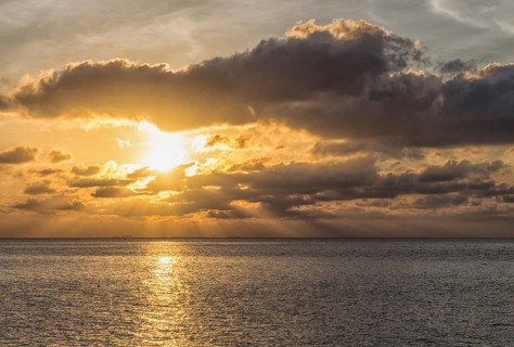 Beautiful sunset over the sea with the sun rays through the clouds, Malaysia, Asia