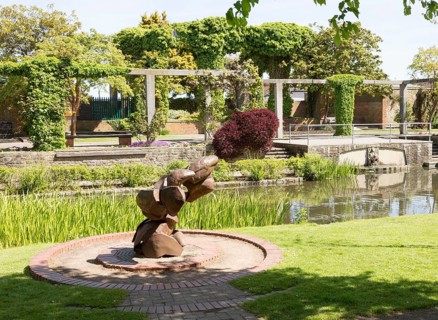 Sculpture water feature and gardens in Queen's Park, central Swindon, Wiltshire, England, UK