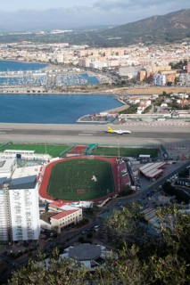 View over airport runway to Spanish town of La Linea from Gibraltar, British overseas territory in