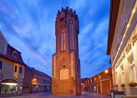 The brick Gothic Owl Tower, illuminated at night, in the old town centre of Tangermünde, Hanseatic