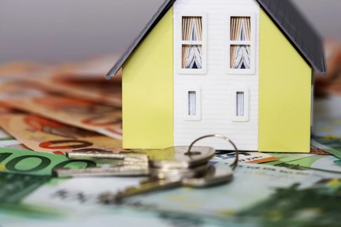 Concept photo with model house, euro notes and coins