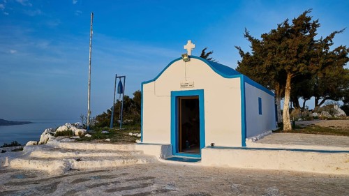 Profitis Ilias Chapel, Small white chapel in front of a rural landscape with blue sky and