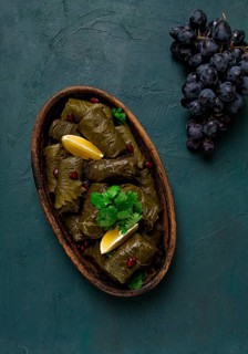 Dolma (Tolma) stuffed rolls, minced meat with rice, in grape leaves, top view, no people, close-up
