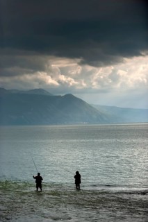Angler in rainy weather against the light, weather, clouds, cloudy, fishing, hobby, fishing on the