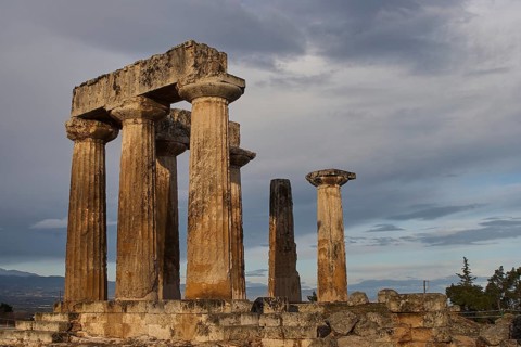 Archaic Temple of Apollo, Doric Columns, Ancient Greek columns stand tall under a dramatic evening