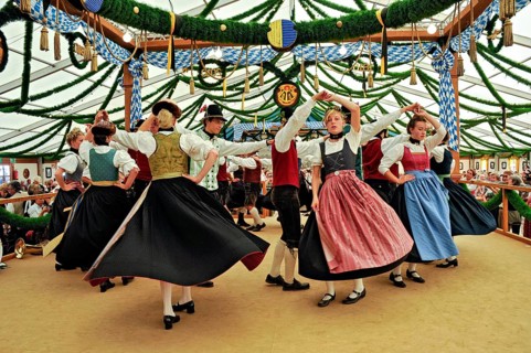 Dancers of a Bavarian folk dance group in traditional traditional costume dancing traditional