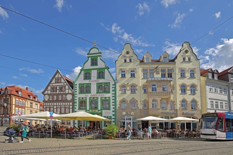 Historic restaurant Hofbräu am Dom with green tail gable, houses and tram, green, street