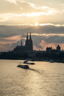 The Rhine near Cologne, sunset, Cologne Cathedral, cargo ship, North Rhine-Westphalia, Germany,