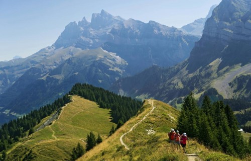 Hikers on the trail over the Arrête de Berroi with a magnificent view of the Dents du Midi mountain