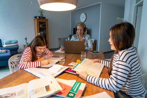 Homeschooling, during the lockdown in January 2021, children learn at home for school, their mum is