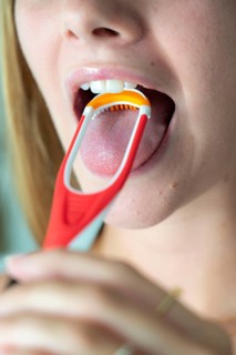 Bad breath, prevention by cleaning the tongue with a tongue brush