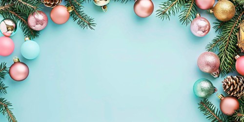 Christmas flatlay with blue, gold and pink colored tree baubles with fir branches on pastel